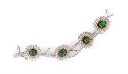 Gold brooch with diamonds and emerald
